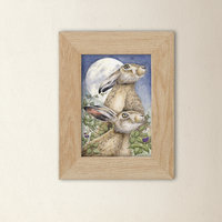 Framed print of a watercolour painting of hares in moonlight