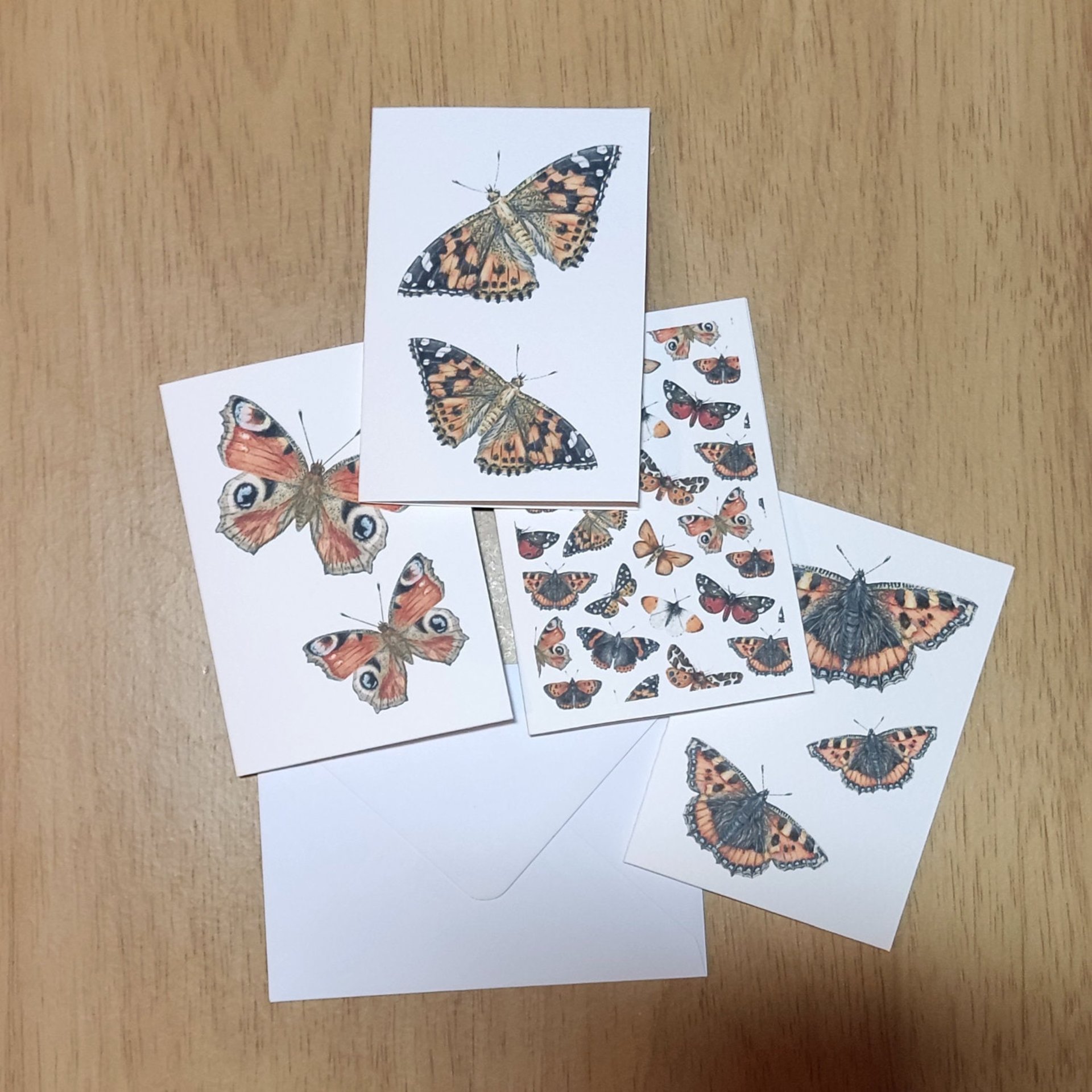 Butterflies mini note cards laying flat on a table top with an envelope
