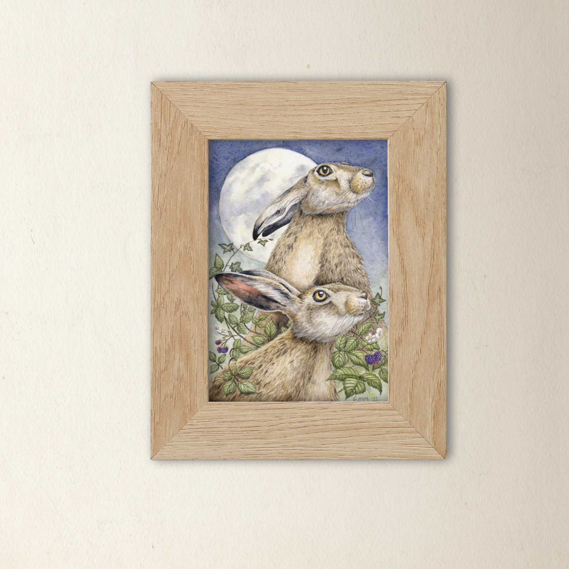 Framed print of a watercolour painting of hares in moonlight