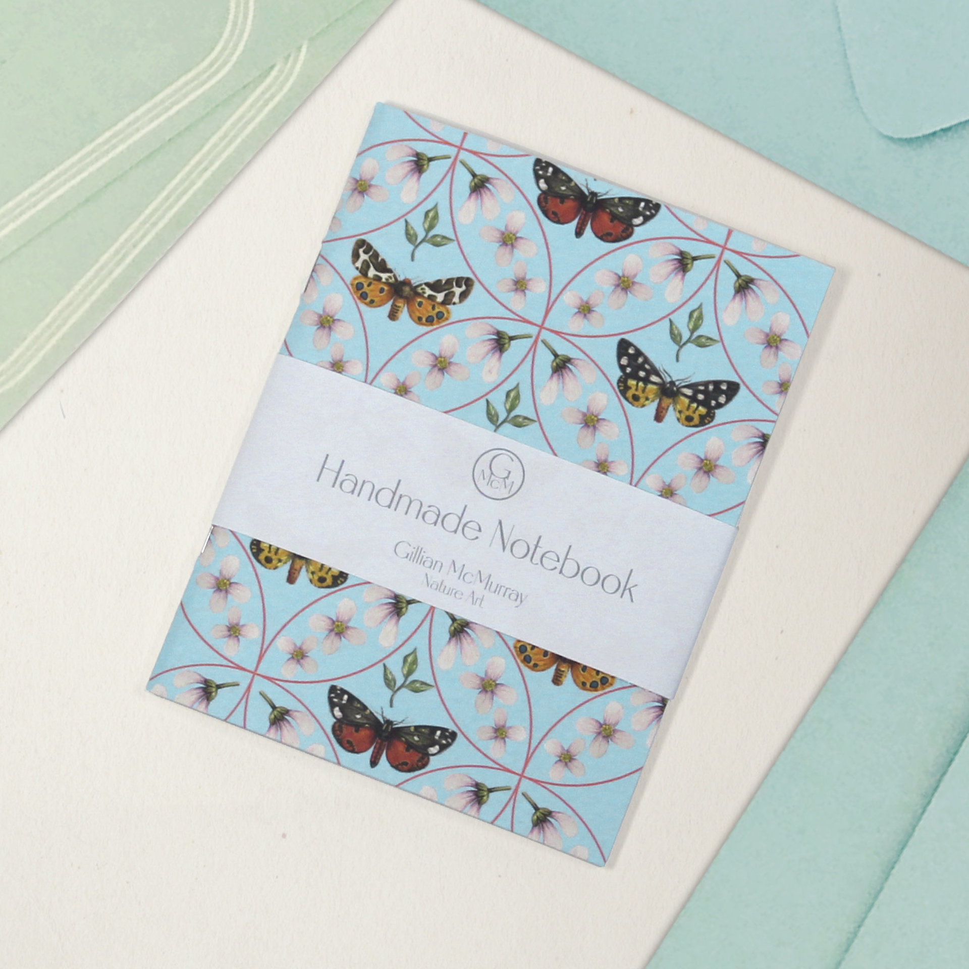 Moth pattern notebook with belly band detailing what it is