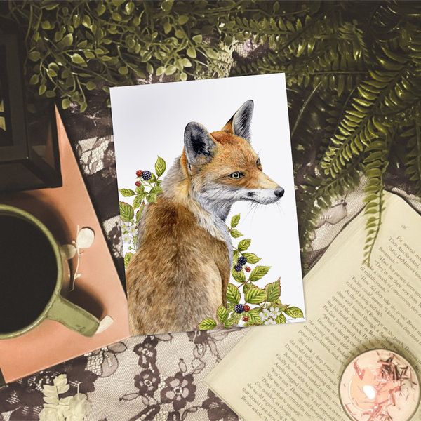 Fox watercolour print sitting on a desk with coffee, books and plants
