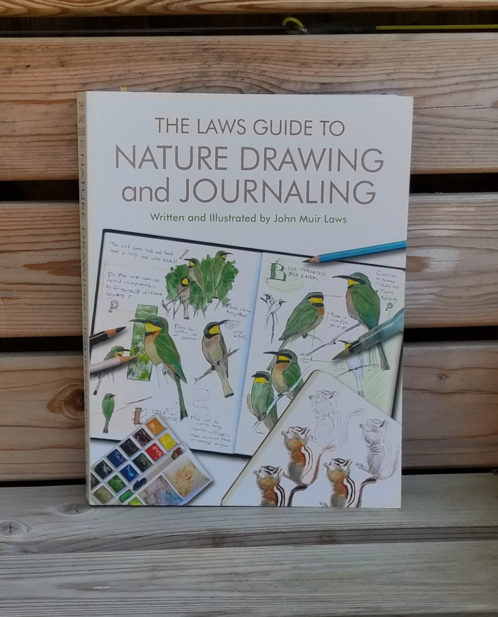 The Laws Guide to Nature Drawing and Journaling lying on a seat